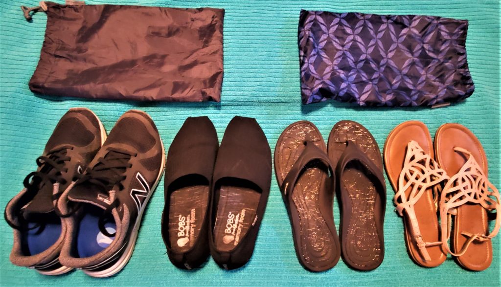 four pairs of shoes for minimal packing with shoe bags